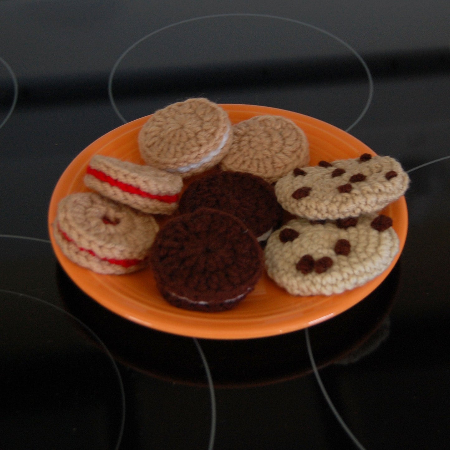 plate of cookies made of yarn on an orange plate
