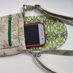 Fabric-wrapped phone with green leaf pattern on a white background