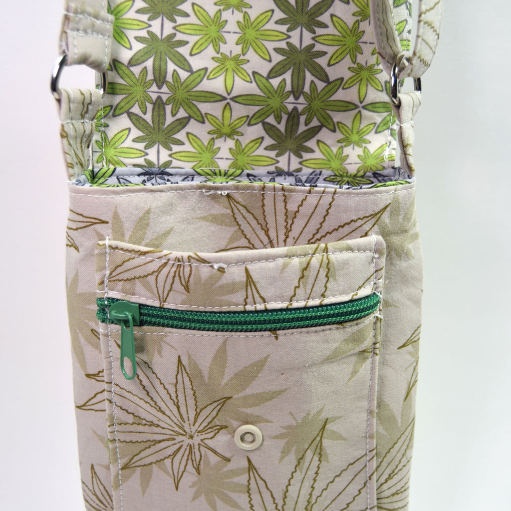Pouch with green leaf pattern and green zipper on a white background