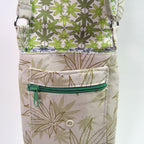 Pouch with green leaf pattern and green zipper on a white background