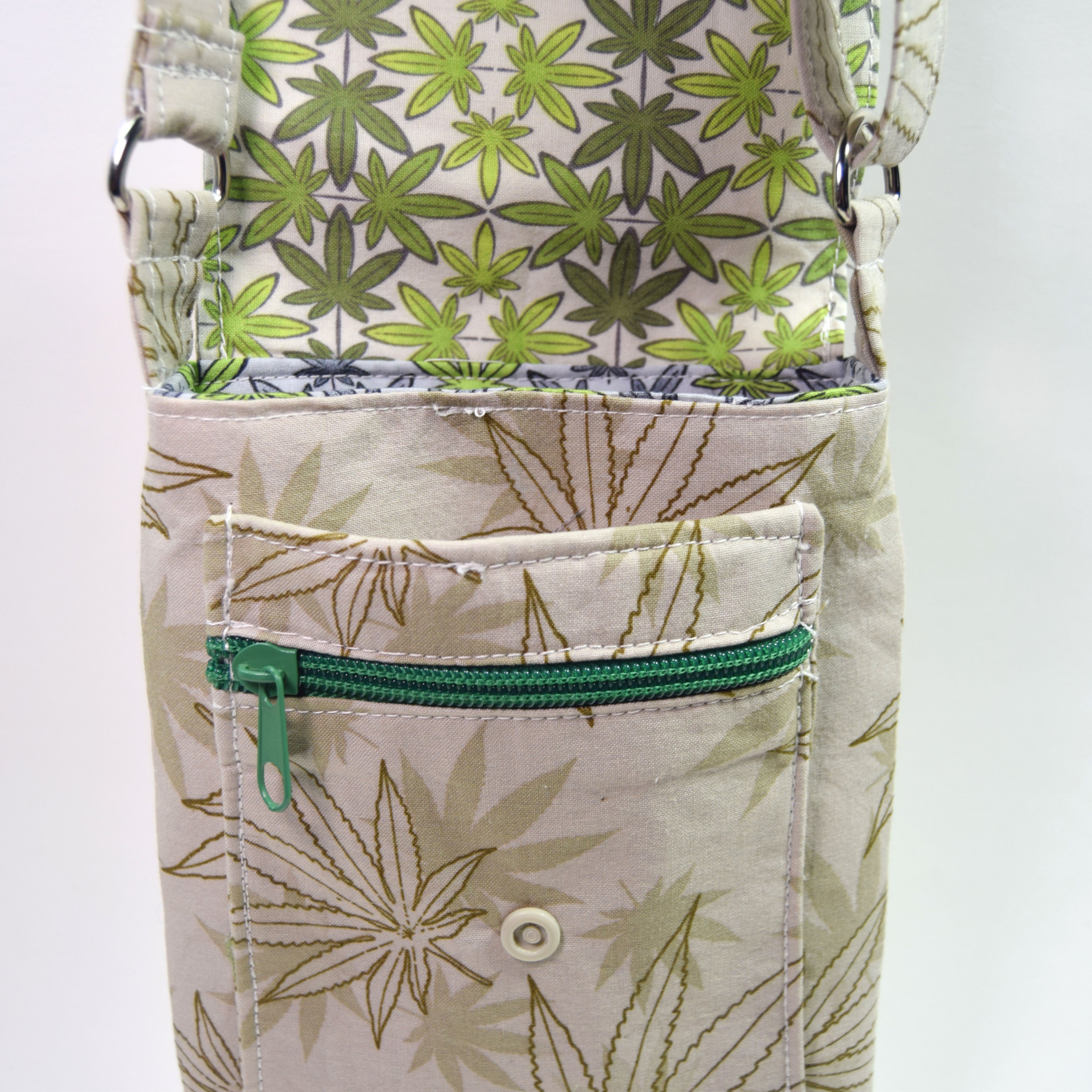 Pouch with green leaf pattern and green zipper on a white background