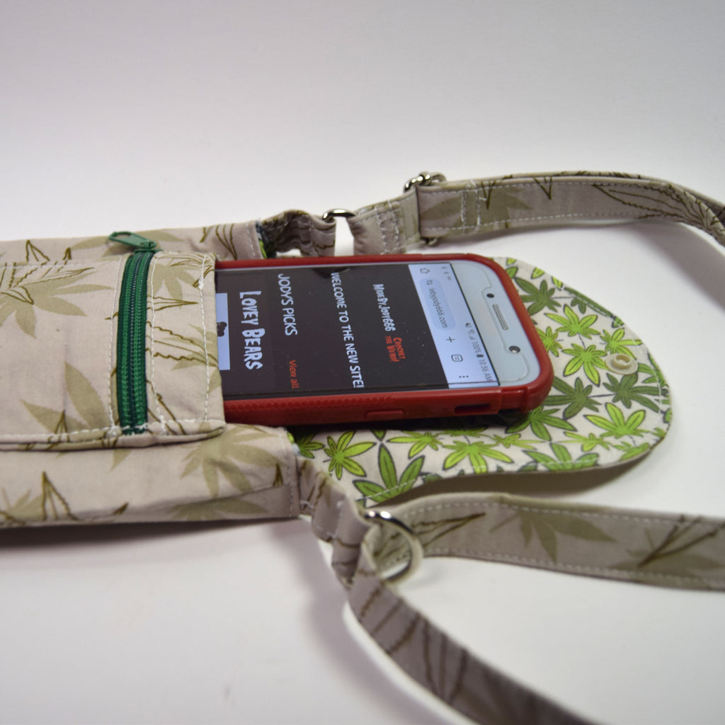 Phone case with a phone inside, placed on a floral-patterned surface