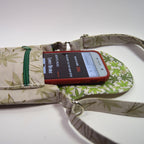 Phone case with a phone inside, placed on a floral-patterned surface