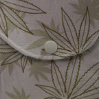 Close-up of a fabric with leaf pattern and button