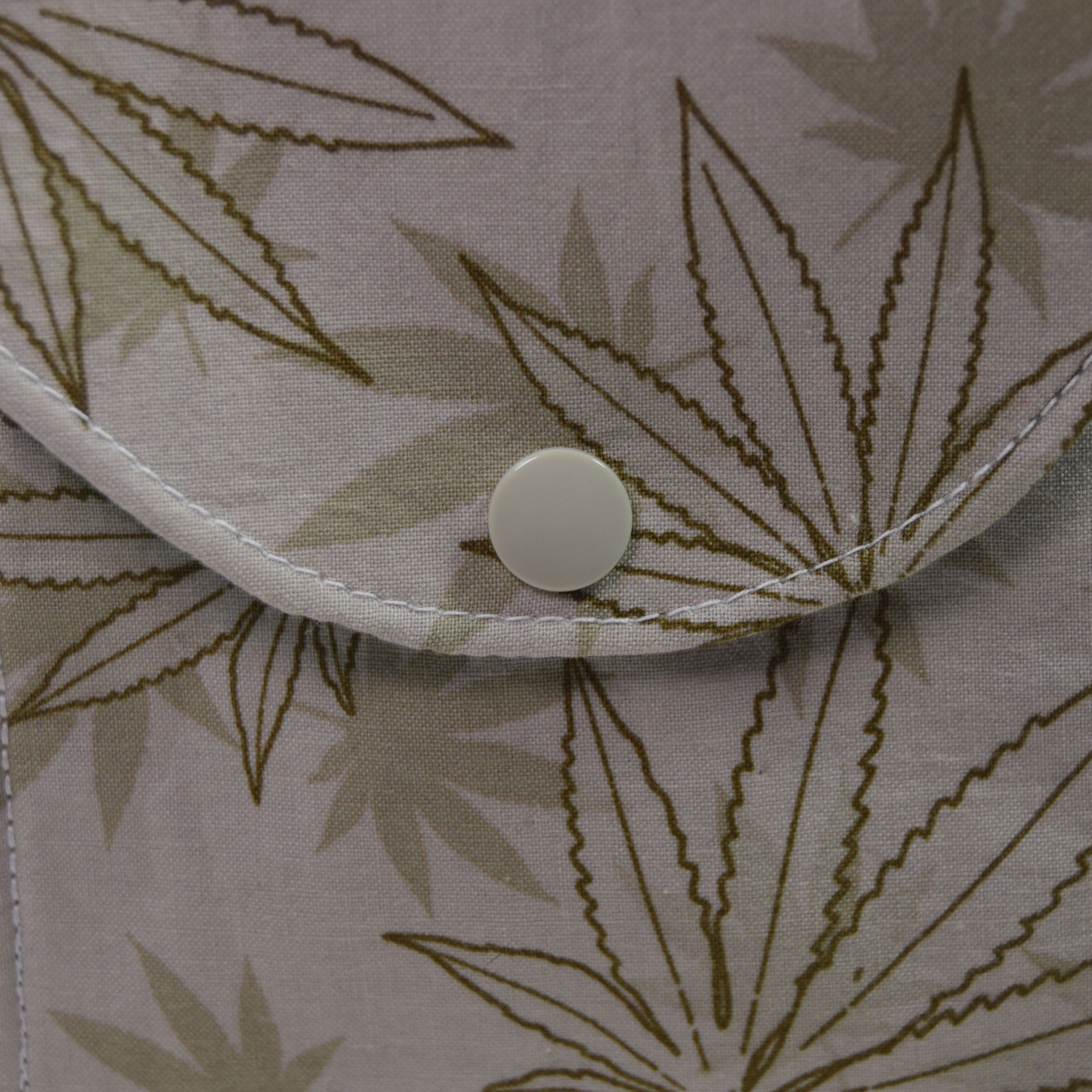 Close-up of a fabric with leaf pattern and button