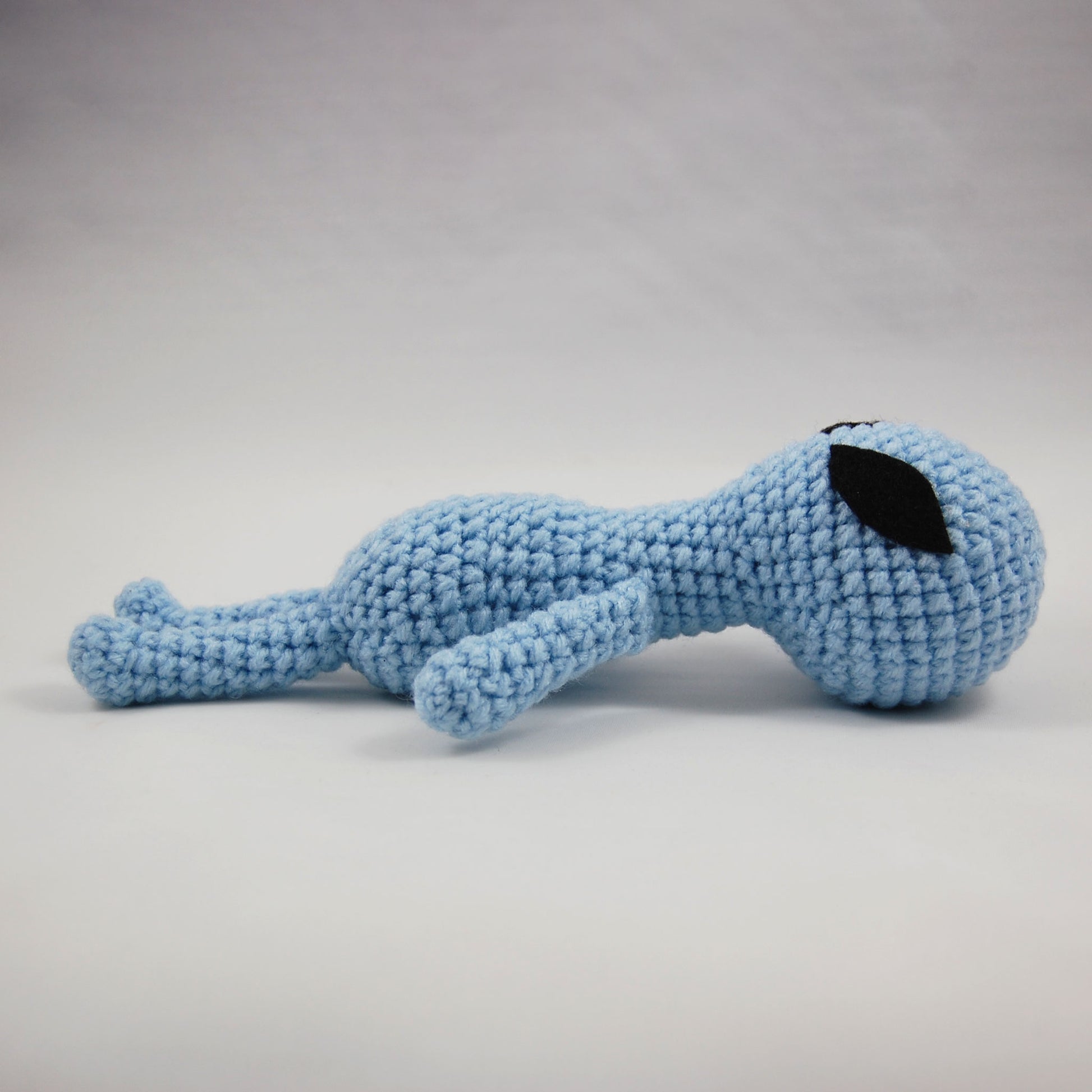 crochet alien doll laying down