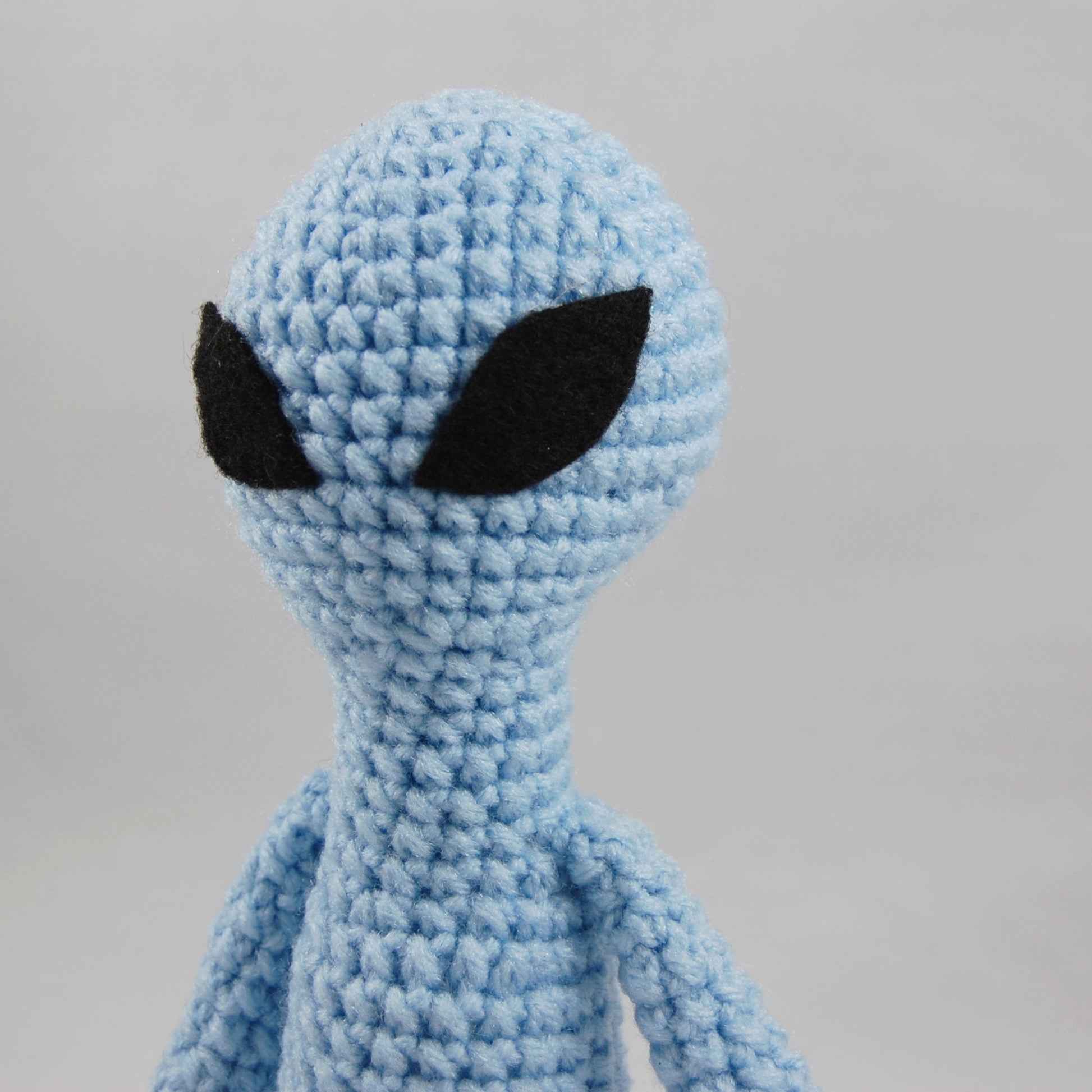 close up of head of alien plush
