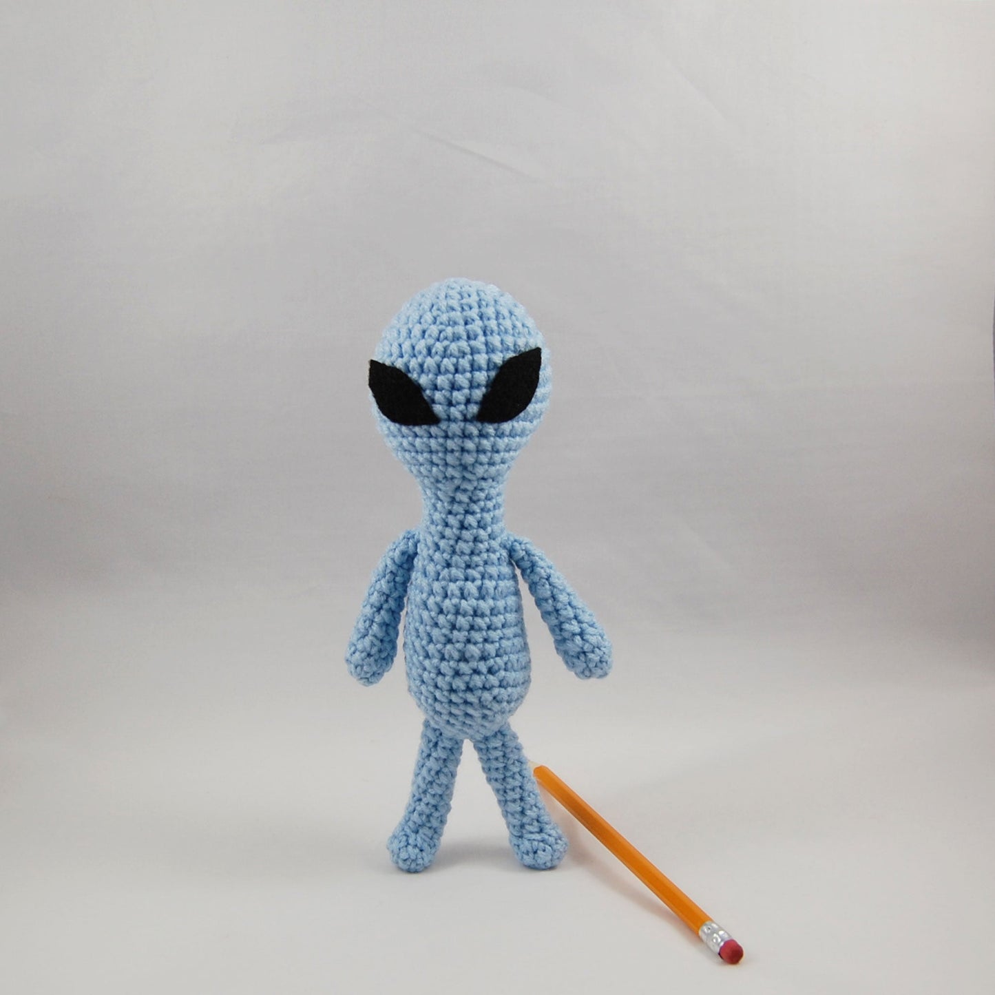 alien plush with pencil