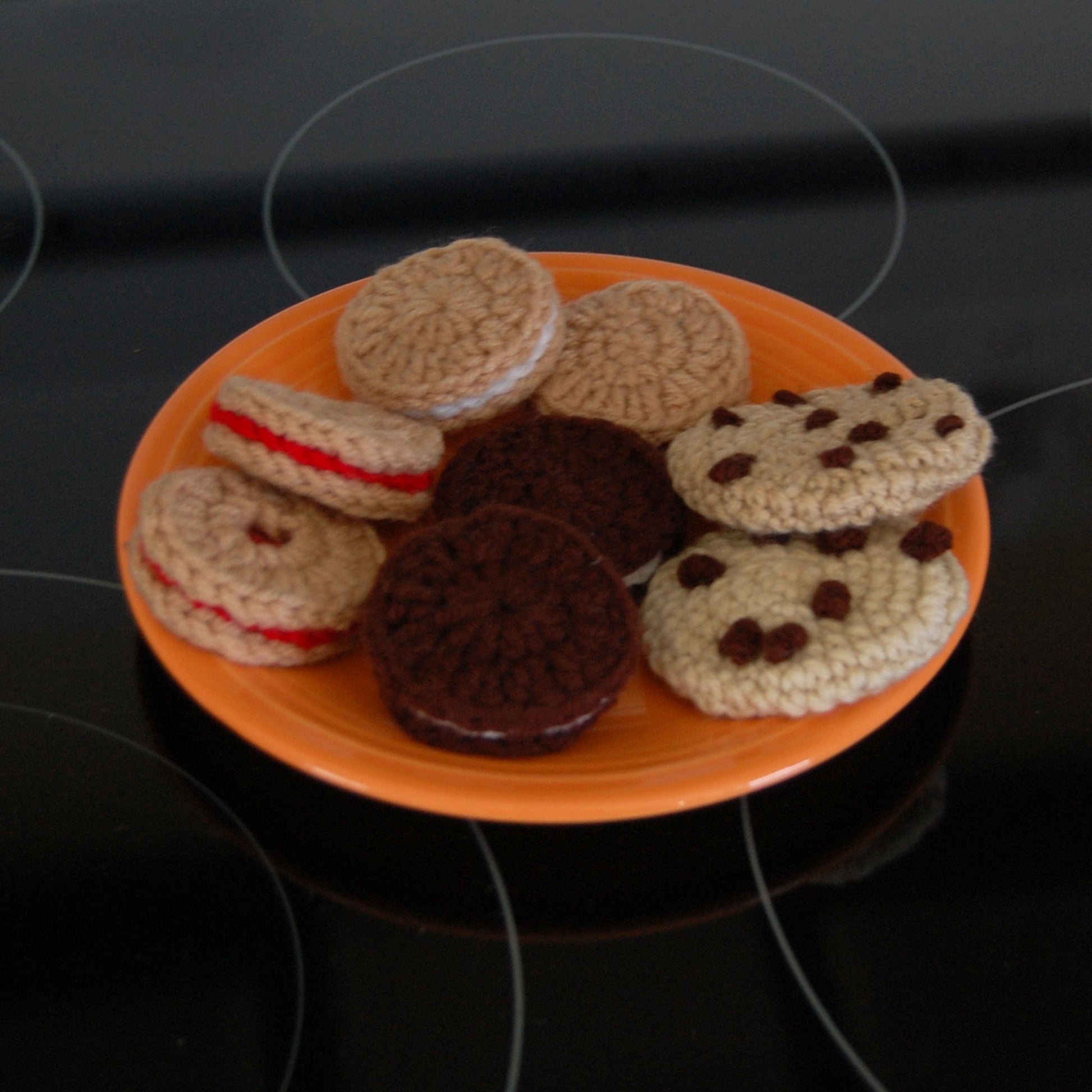 plate of cookies made of yarn on an orange plate